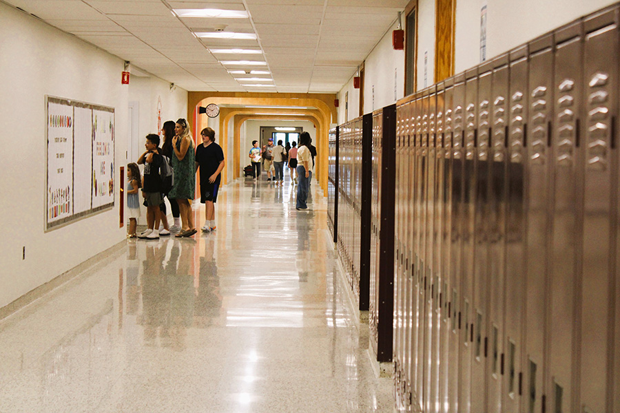 hallway photo with families and students finding lockers.