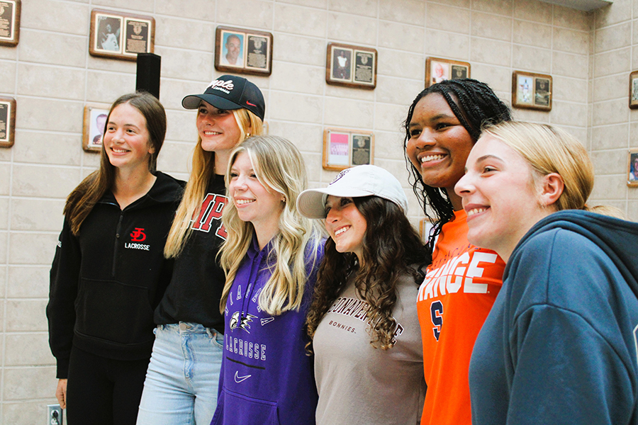 Student-athletes pose for group photo after National Letter of Intent signing event.