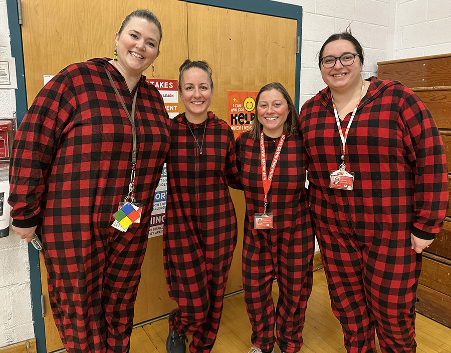 Moses DeWitt staff wearing holiday pajamas in group photo.