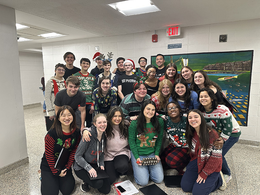 In Achord poses for group photo after caroling at the high school.