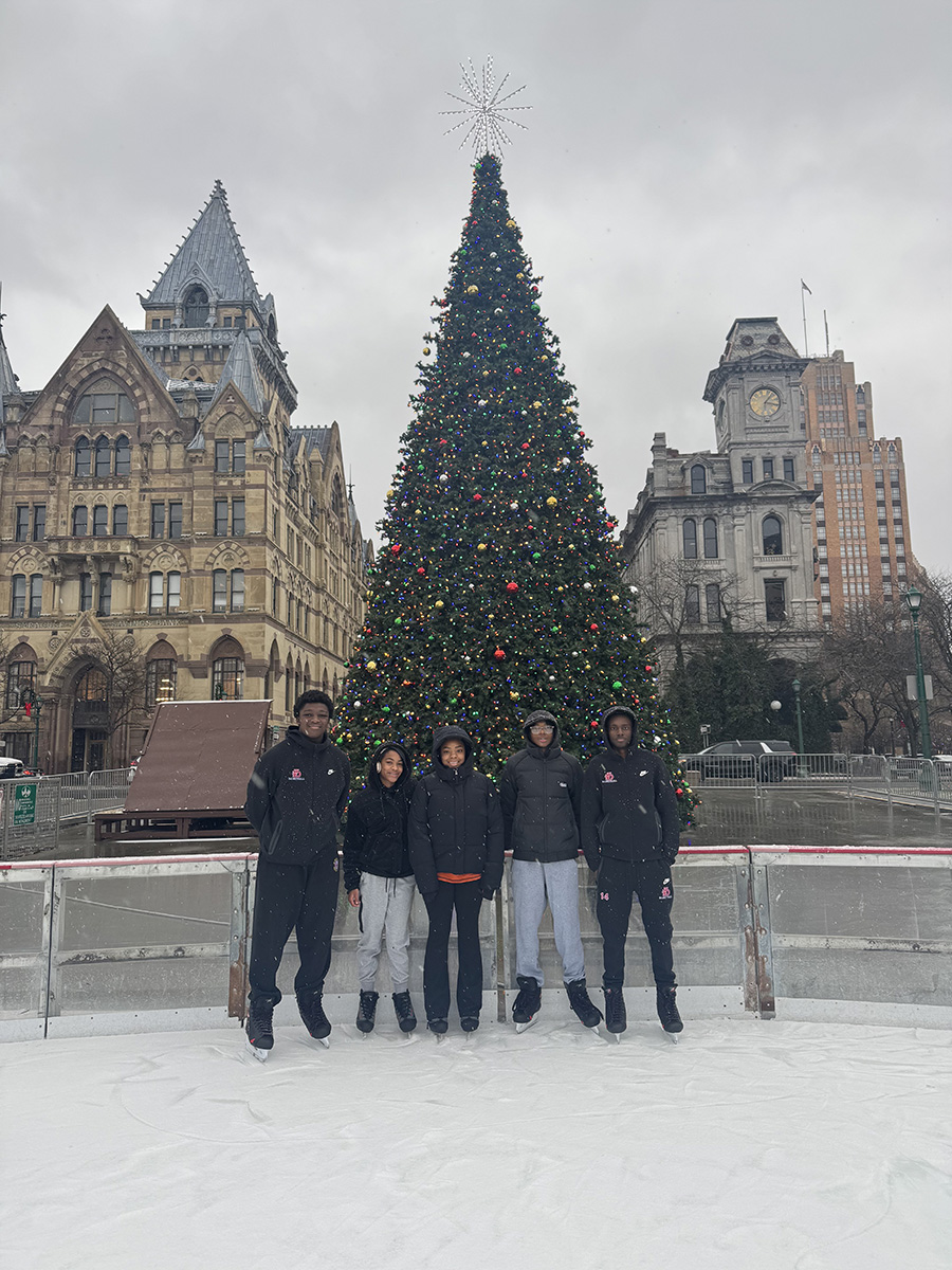 Club Umoja members pose for photo while ice skating at Clinton Square.