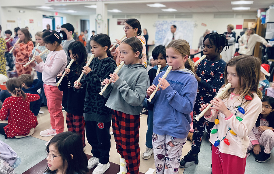 Tecumseh third graders perform with recorders at holiday event.