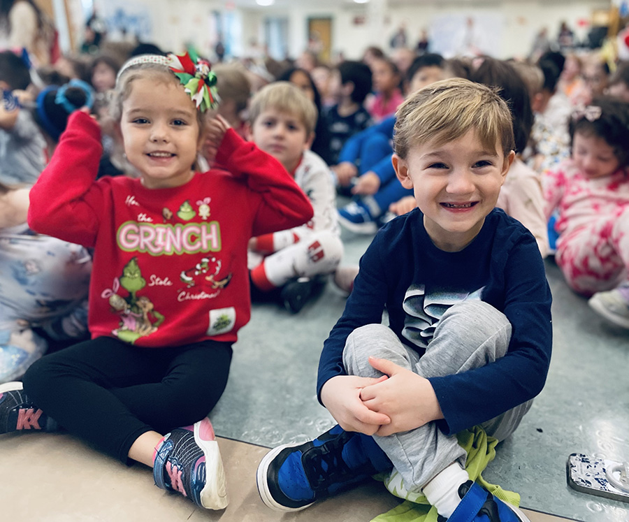 Tecumseh students smile for camera during holiday assembly.