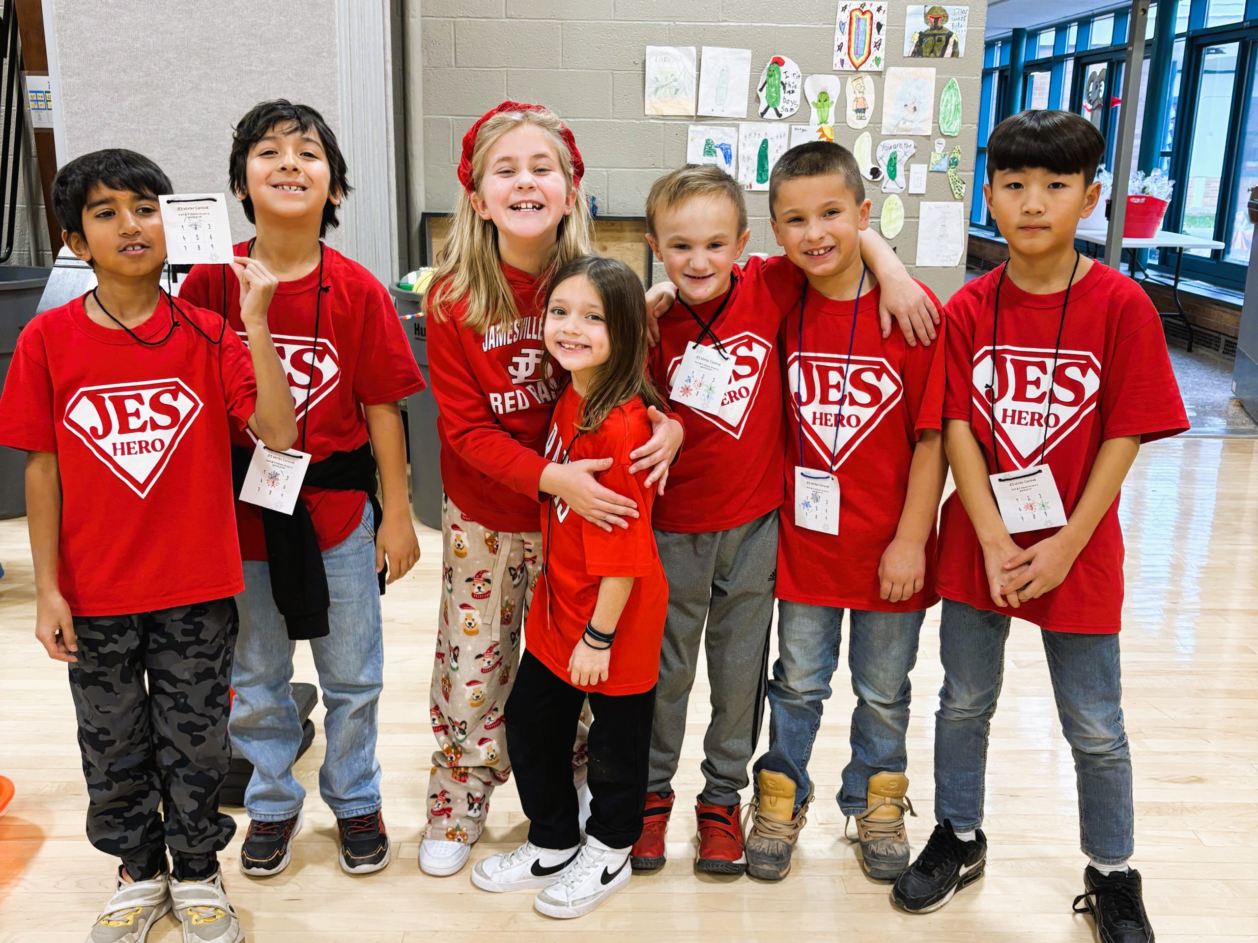 Group of JES students pose for photo wearing JES Hero shirts.