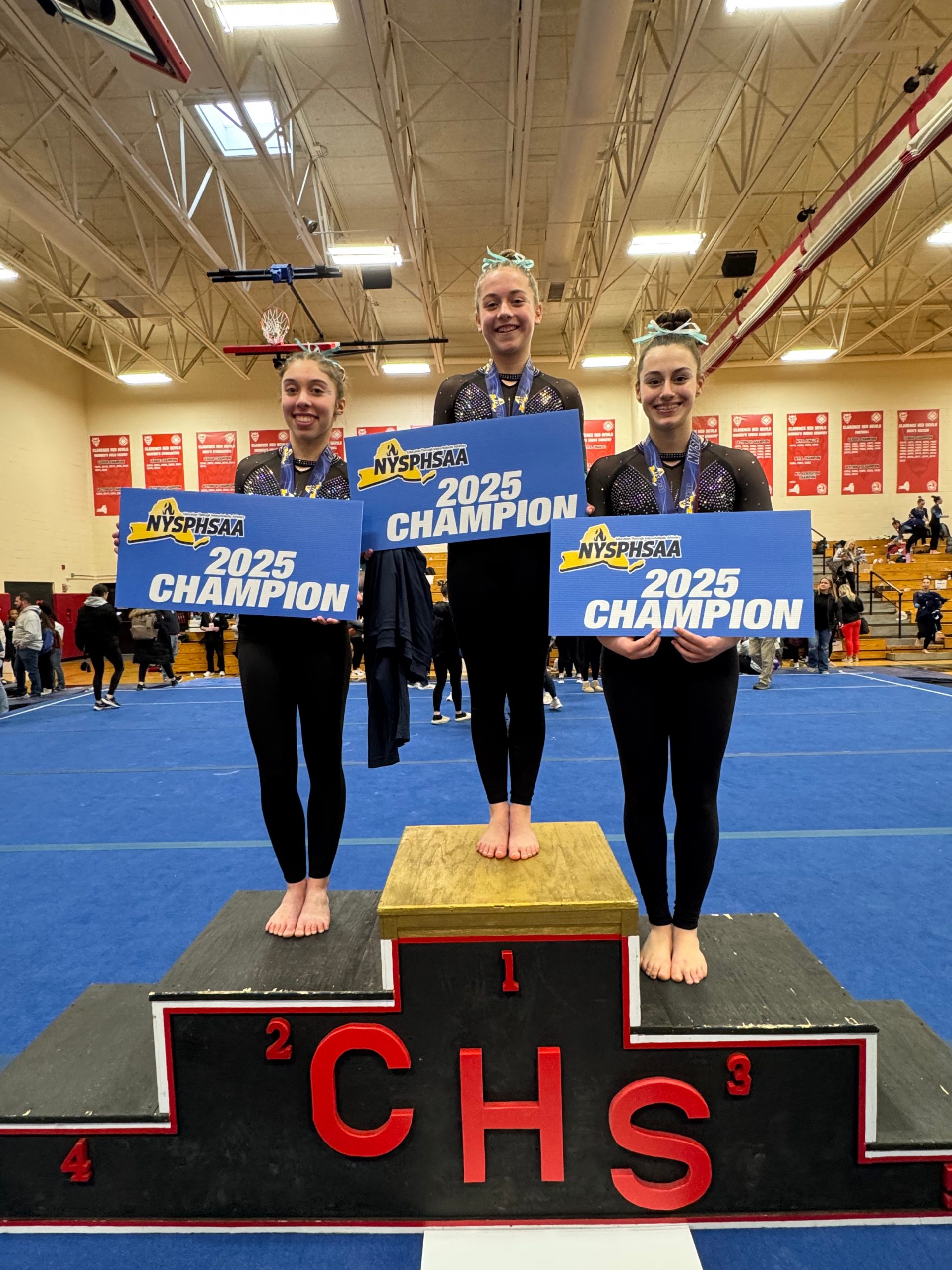 Ailey Babikian NYS Section III Champion in Gymnastics poses for photo on podium.