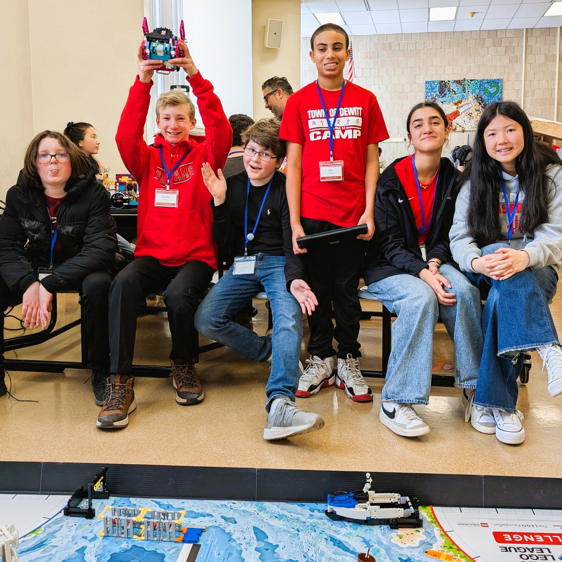 Students involved in Lego robotics club pose for photo with trophy.