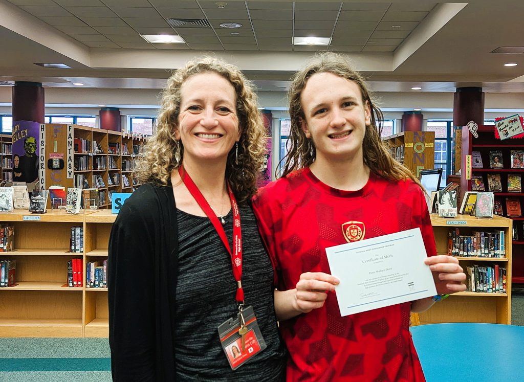 Jamesville-DeWitt High School senior Peter Drew poses for National Merit Finalist photo with his mother.